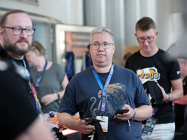 Gary and Matt receive their lanyards at the start of TYPO3 Dev Days 2026.