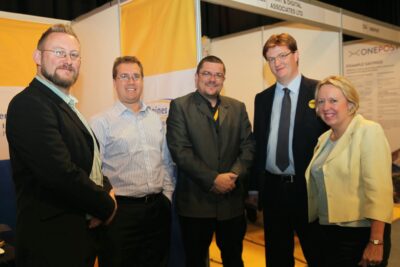 Danny Alexander and Lorely Burt visiting the Prater Raines stand at conference